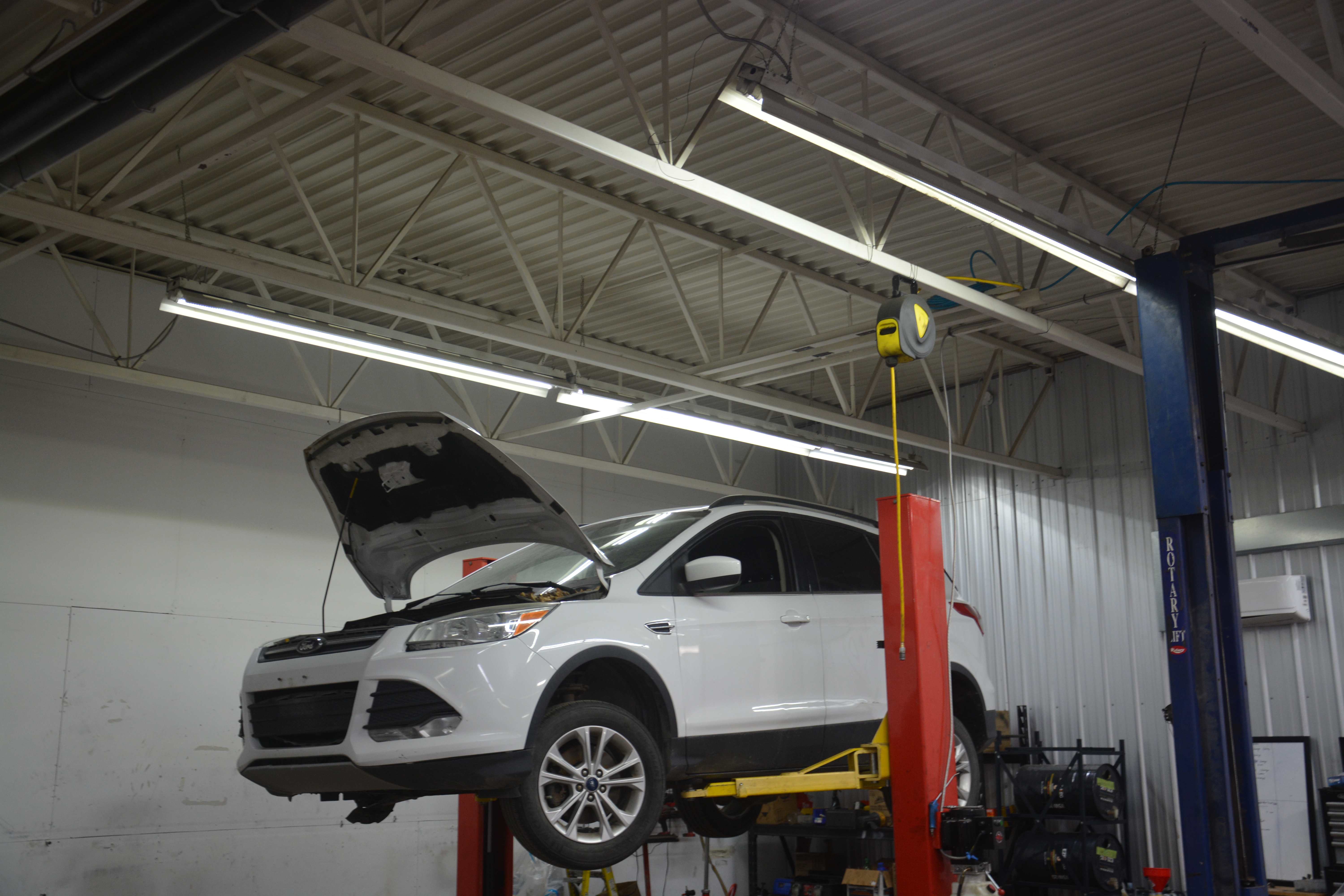 White vehicle on professional lift